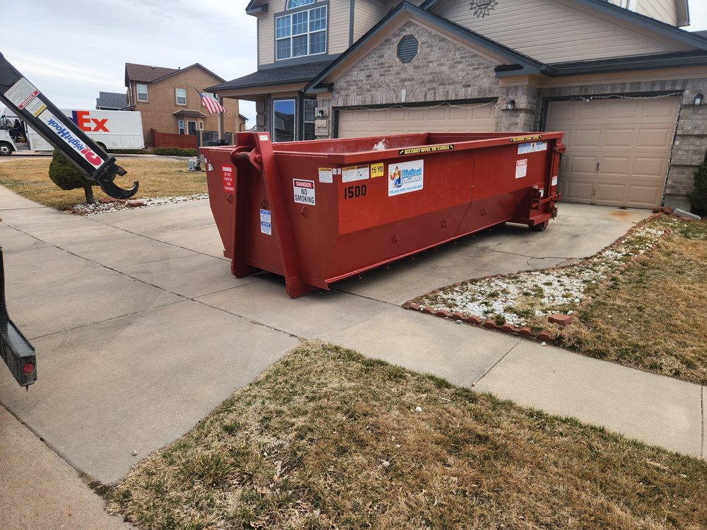 Bigfoot Portables dumpster dropped in a driveway for a home cleanout